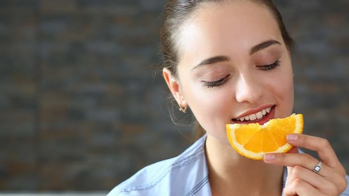 a person eating citrus fruits etc