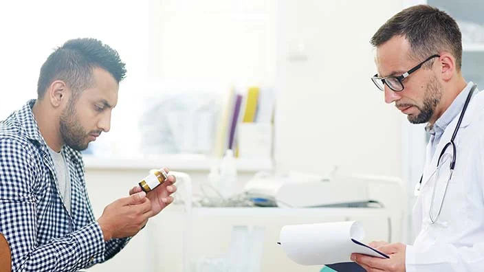 patient getting prescription from physician written over adderall