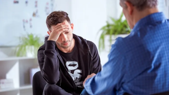 man meeting with therapists for disucssion